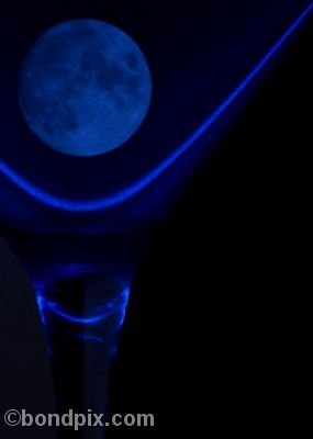 Blue moon in a glass lit by laser