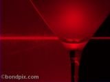 Still life of red laser light shining through a glass