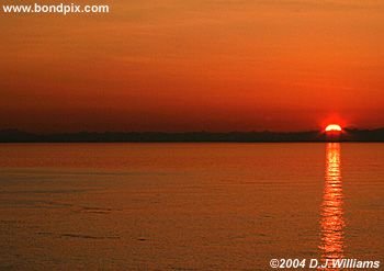 Sun reflected in the water during sunrise over the Inside Passage Alaska