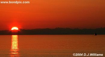Sun reflected in the water during sunrise over the Inside Passage Alaska
