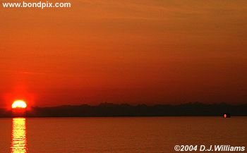 Sun reflected in the water during sunrise over the Inside Passage Alaska