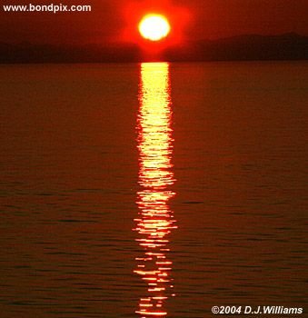Sun reflected in the water during sunrise over the Inside Passage Alaska